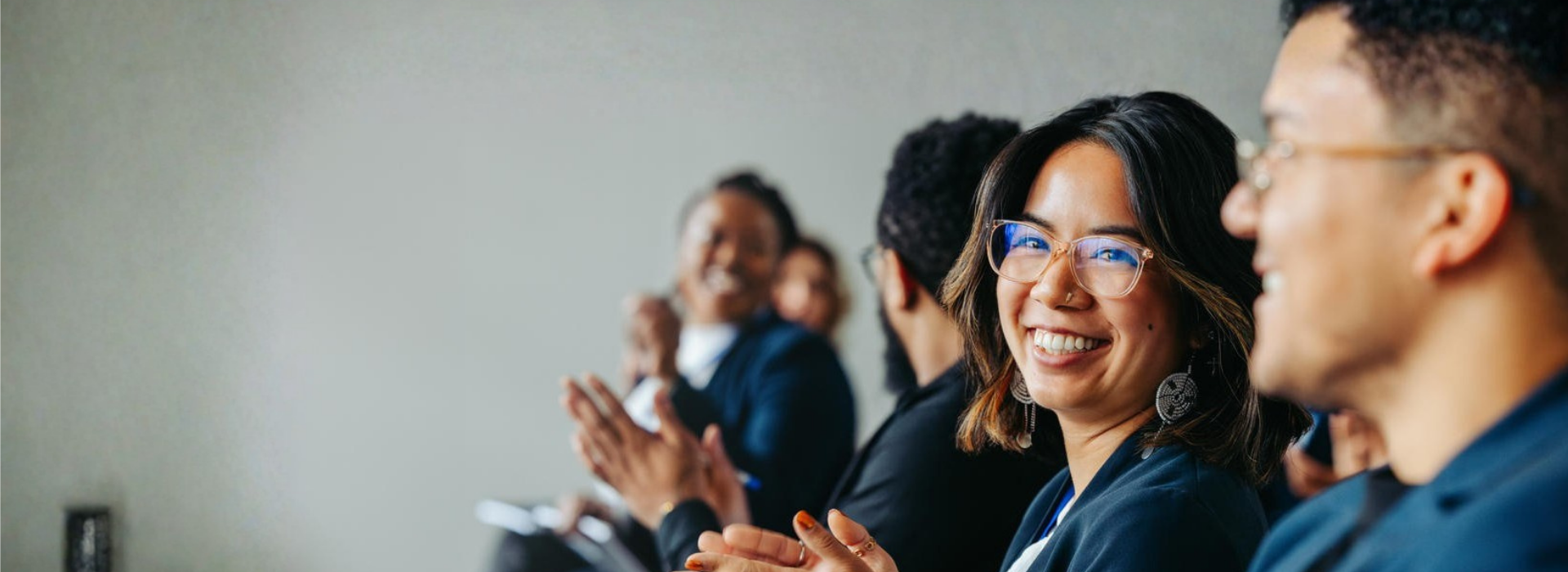 Group of professionals smiling and applauding during a Human Resources event at the University of Ottawa.